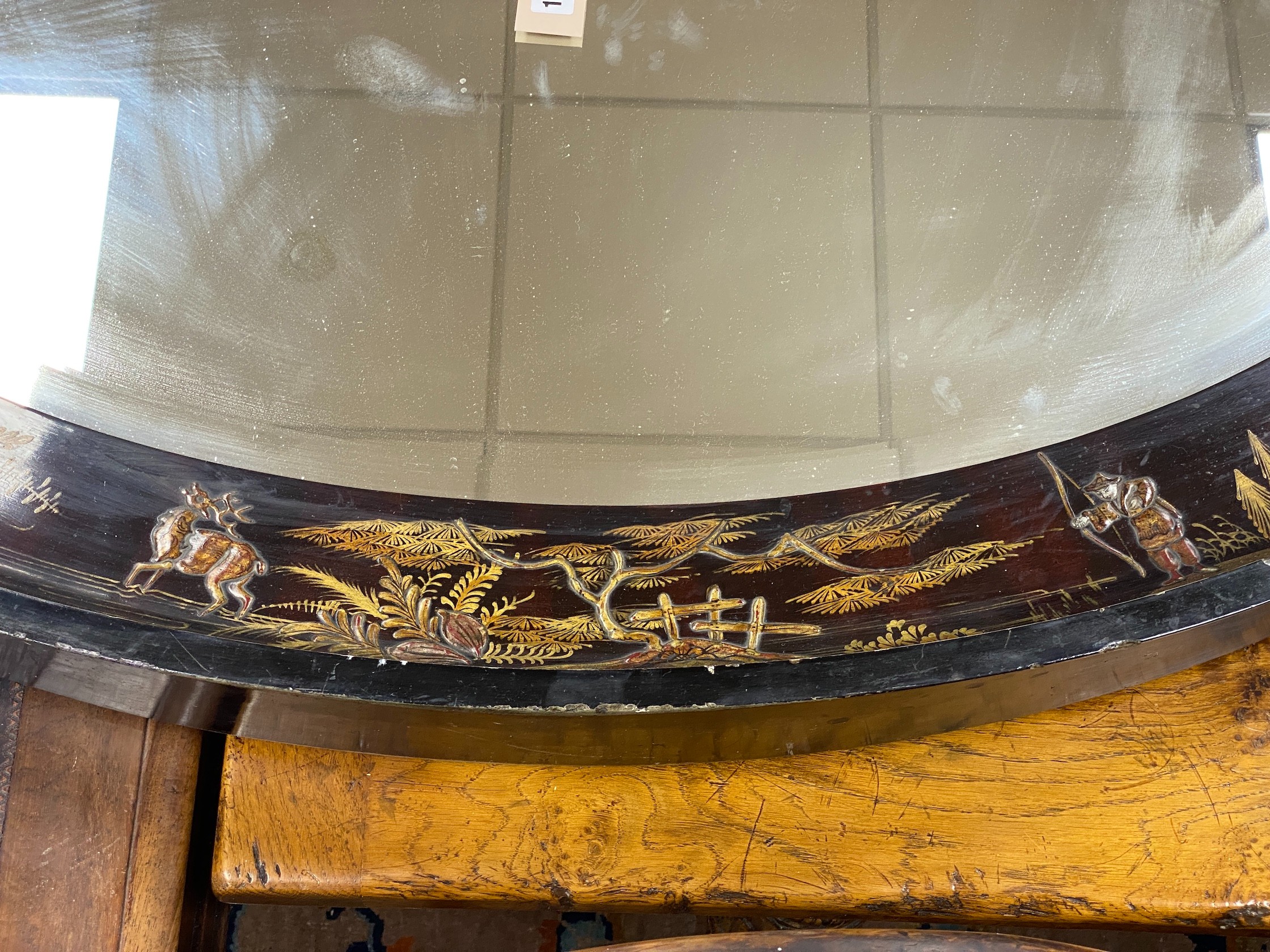 An early 20th century oval chinoiserie lacquered oval wall mirror, width 117cm, height 78cm